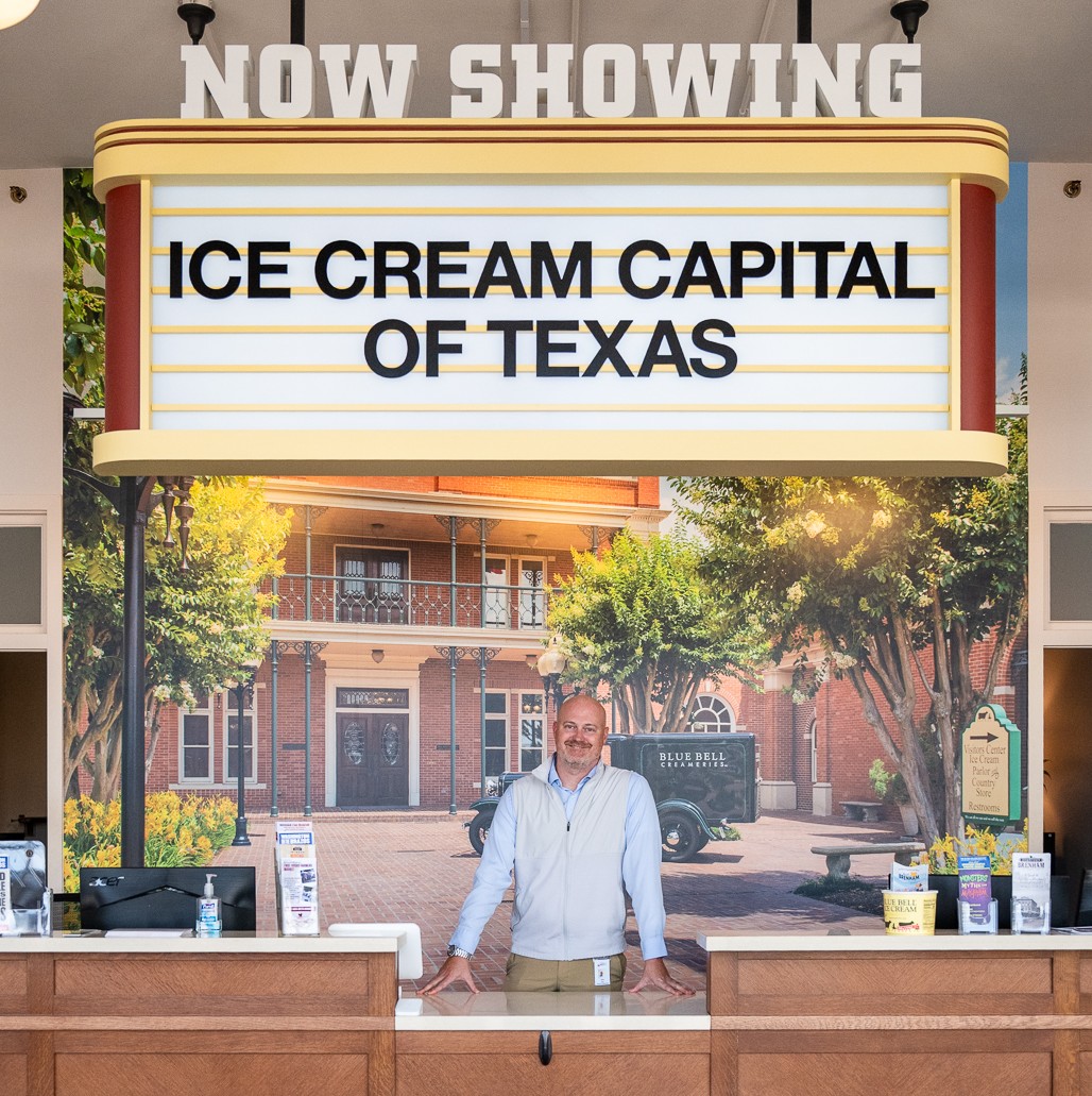 Kris Gore standing at the front desk of the Brenham/Washington County Visitor Center